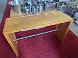 several pots and pans are on a wooden table in a kitchen