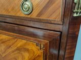 a wooden cabinet with a marble top and brass handles
