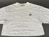 a white t - shirt with black dots on the front and a small black dot on the back