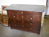 a dresser with a marble top in the middle of a room