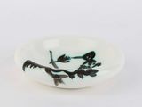 a small bowl with a bird on a branch on it
