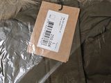 a label on the back of a jacket that is wrapped in plastic