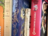 many books that are lined up on a shelf
