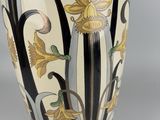 a vase that has flowers on it on a table
