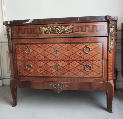an antique chest of drawers in a room with a wall in the background