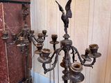 a metal candelab with a bird on top of it