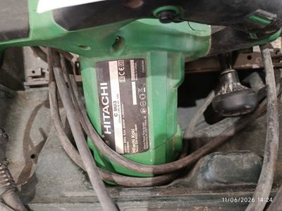 a close up of a green drill on the ground