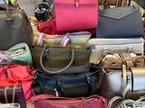 a lot of purses on a table in a store