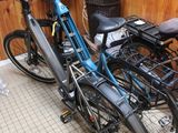 many bikes that are parked in a room together