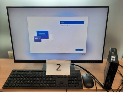 a computer monitor with a keyboard and mouse on a desk