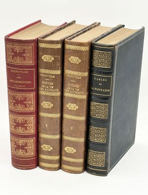 three books are stacked on top of each other on a white surface