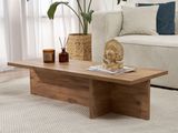 a coffee table with a statue on top of it in a living room
