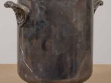a large metal pot sitting on top of a wooden table