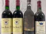 four bottles of wine are lined up on a table