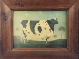 un tableau représentant une vache, monté dans un cadre en bois