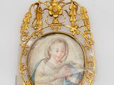 an old picture of a woman holding a baby in a gold frame