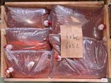 a wooden box filled with plastic bags and a sign