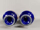 pair of blue vases sitting on top of a white table