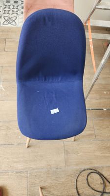 a blue chair that is sitting on a hard wood floor