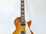 an electric guitar sitting on top of a stand on a white surface