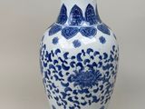 a blue and white vase sitting on a table