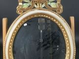 a mirror with a gold frame and a mirror with flowers on it