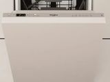 a close up of a dishwasher in a white kitchen