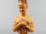 a carved bust of a woman holding a baby in her arms