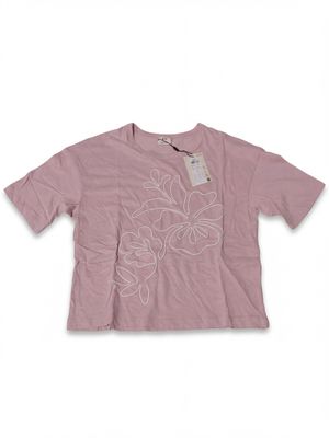 a pink t - shirt with white flowers on the chest