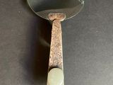a mirror that is sitting on a table with a spoon