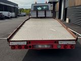 a flatbed truck that is parked in a parking lot