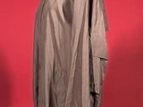 grey jacket on a mannequin stand against a red background