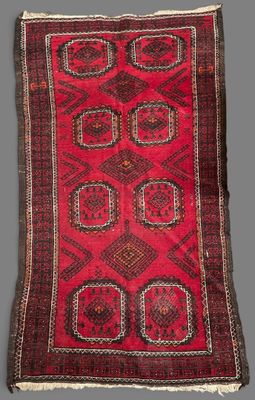 a red and black rug on a grey background
