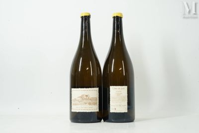 two bottles of wine sitting on top of a white table