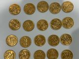 some gold coins are arranged in a circle on a white surface