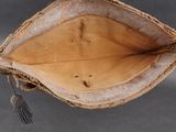 an old baseball glove with a tassel hanging from it