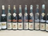 many bottles of wine that are lined up on a table