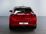 the rear end of a red car in a white room