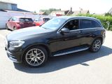 the mercedes gle is parked in a parking lot with other cars