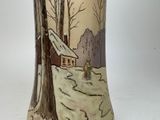 a vase that has a picture of a house on it