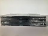 a stack of dvds sitting on top of a white table