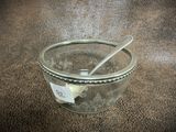 a glass jar with a spoon in it on a table