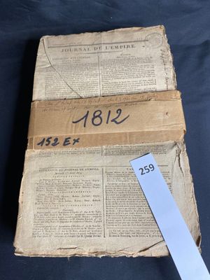 an old book that has a ruler on top of it