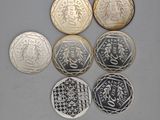 six different british coins with chinese writing on them