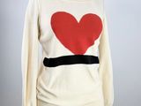 an image of a white sweater with a red heart on it