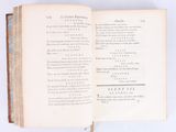 an open book on a white surface with a picture of a cat