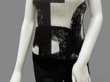 a mannequin wearing a black and white top and black pants