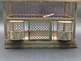a bird in a cage that is sitting on a table