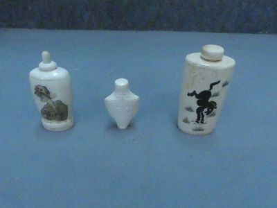 three small vases sitting on a blue surface