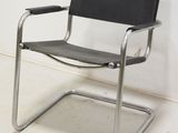 an image of a black leather chair in a white room